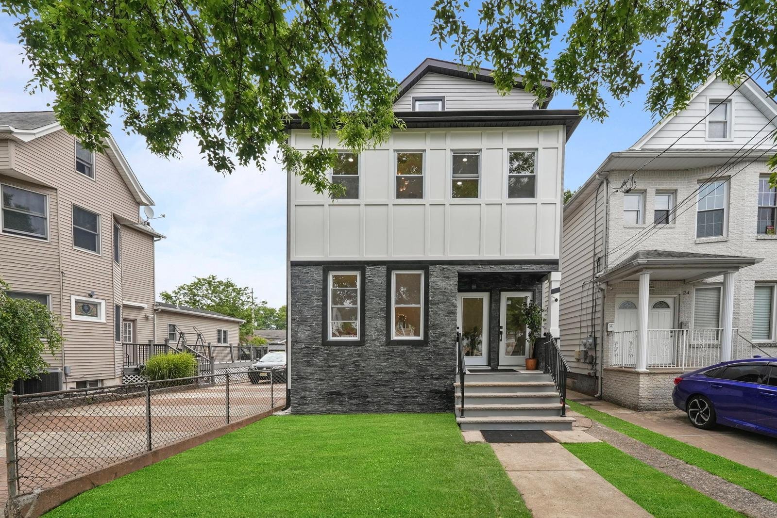 Renovated white and charcoal facade at a Pilla project in Wallington, New Jersey